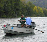 Yoshiro puts a Steelhead back to swim in the Rogue River, Oregon